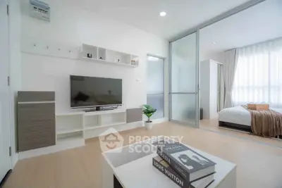 Modern living room with sliding doors leading to a cozy bedroom, featuring stylish decor and natural light.