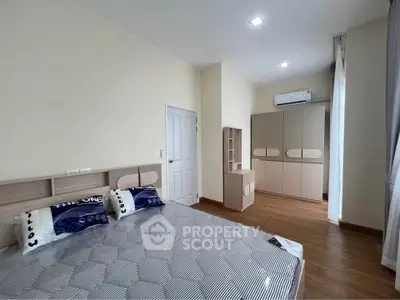 Spacious bedroom with modern furnishings and ample natural light