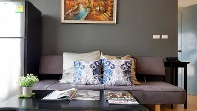 Stylish living room with modern decor and cozy seating in a contemporary apartment.