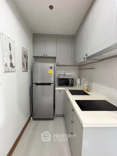 Modern compact kitchen with sleek appliances and stylish cabinetry