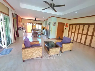 Spacious open-layout living room with modern kitchen and stylish furniture