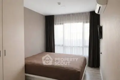 Modern bedroom with large window and air conditioning in a stylish apartment.