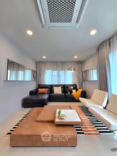 Modern living room with stylish furniture and elegant decor, featuring a cozy sectional sofa and chic lighting.