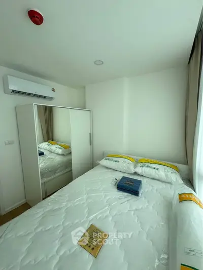 Bright and cozy bedroom with modern air conditioning and ample storage space.