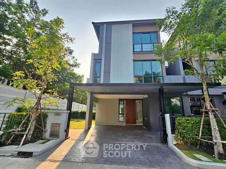 Modern three-story house with sleek design and spacious driveway