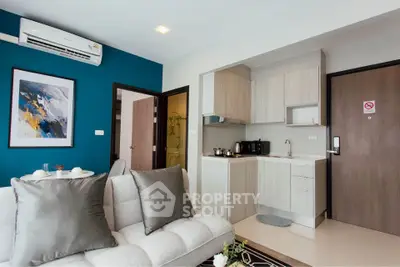 Modern living room with compact kitchen and stylish decor