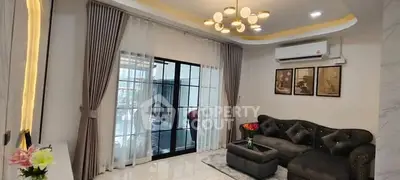 Elegant living room with modern decor, stylish lighting, and large windows for natural light.