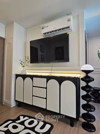 Modern living room with stylish TV console and air conditioning unit