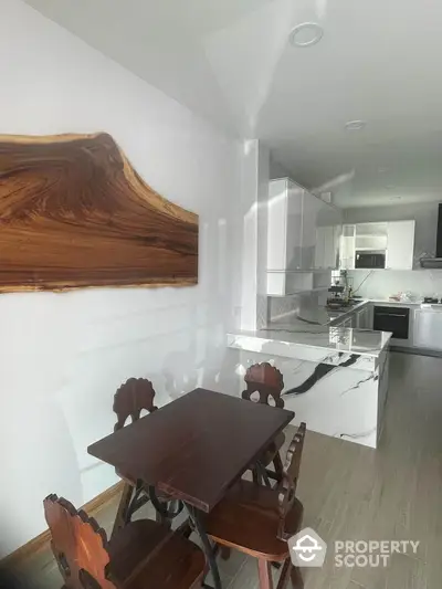 Modern kitchen with elegant wooden dining set and marble countertops