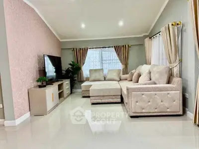 Spacious and elegant living room with plush seating and modern decor, perfect for relaxation and entertainment.