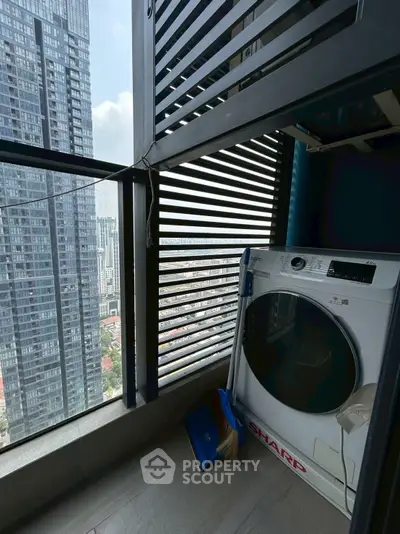 High-rise balcony with city view and washing machine, perfect for urban living.