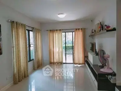 Bright living room with large windows and modern decor, perfect for relaxation.