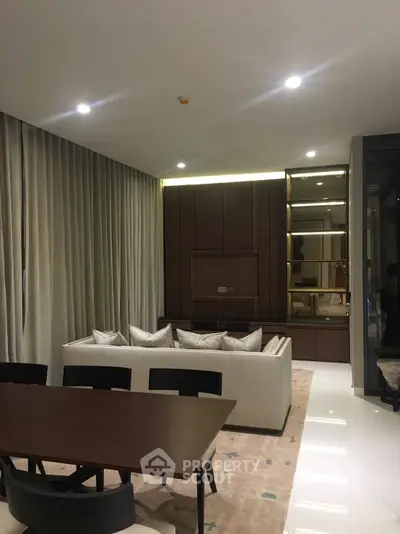 Luxurious modern living room with elegant sofa and dining area, perfect for stylish urban living.