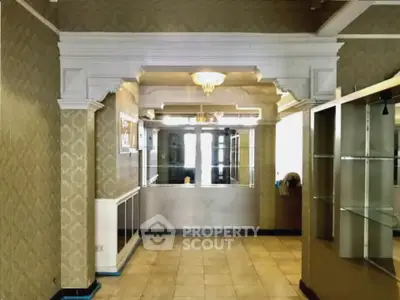 Elegant interior with classic molding and chandelier, perfect for a sophisticated living space.