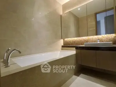 Luxurious bathroom with elegant bathtub and modern vanity in upscale property.