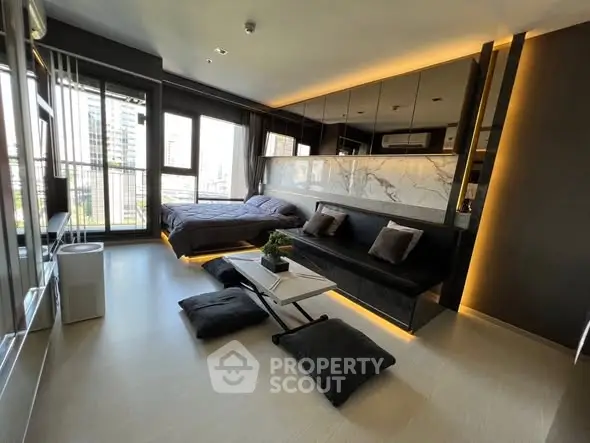 Modern studio apartment with sleek design and city view, featuring a cozy living area and stylish bedroom.