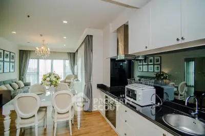 Luxurious open-plan living and dining area with elegant decor and modern kitchen.
