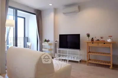 Modern living room with balcony access and stylish furniture