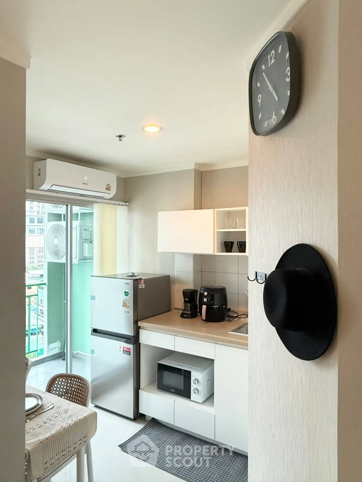 Modern kitchen with balcony access, featuring sleek appliances and stylish decor.