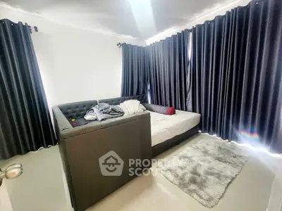 Spacious bedroom with modern sofa bed and blackout curtains