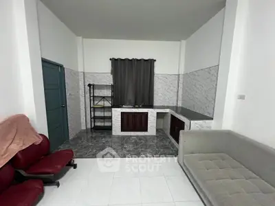 Modern living room with sleek tiled walls and comfortable seating in a stylish apartment.