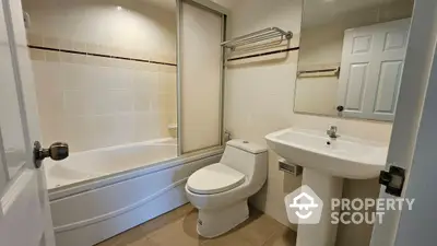 Modern bathroom with bathtub and sleek fixtures in a contemporary home.