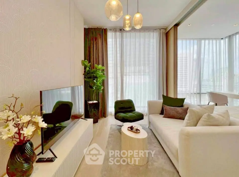 Modern living room with elegant decor, large windows, and stylish furniture in a high-rise apartment.