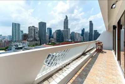 Stunning cityscape view from a spacious balcony in a modern high-rise apartment.