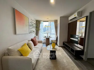 Modern living room with city view, stylish decor, and cozy seating area.
