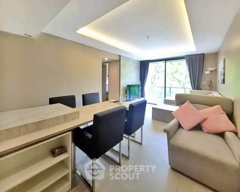 Spacious modern living room with dining area and large window view