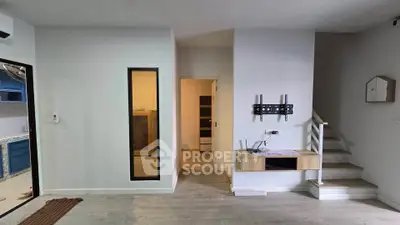 Modern interior with staircase and wall-mounted TV bracket in a stylish living space.