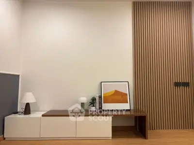 Modern living room with stylish wooden paneling and minimalist decor