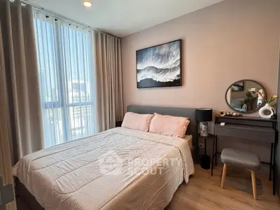 Cozy bedroom with modern decor and large window for natural light