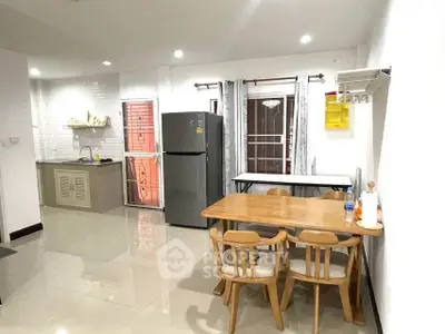 Spacious kitchen with dining area, modern appliances, and sleek design.