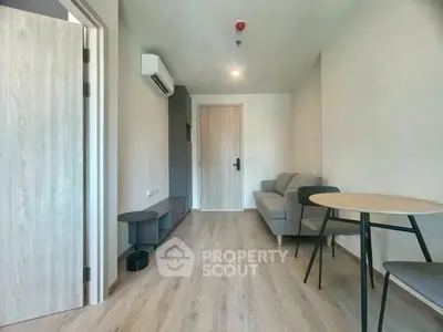 Modern living room with minimalist furniture and wooden flooring