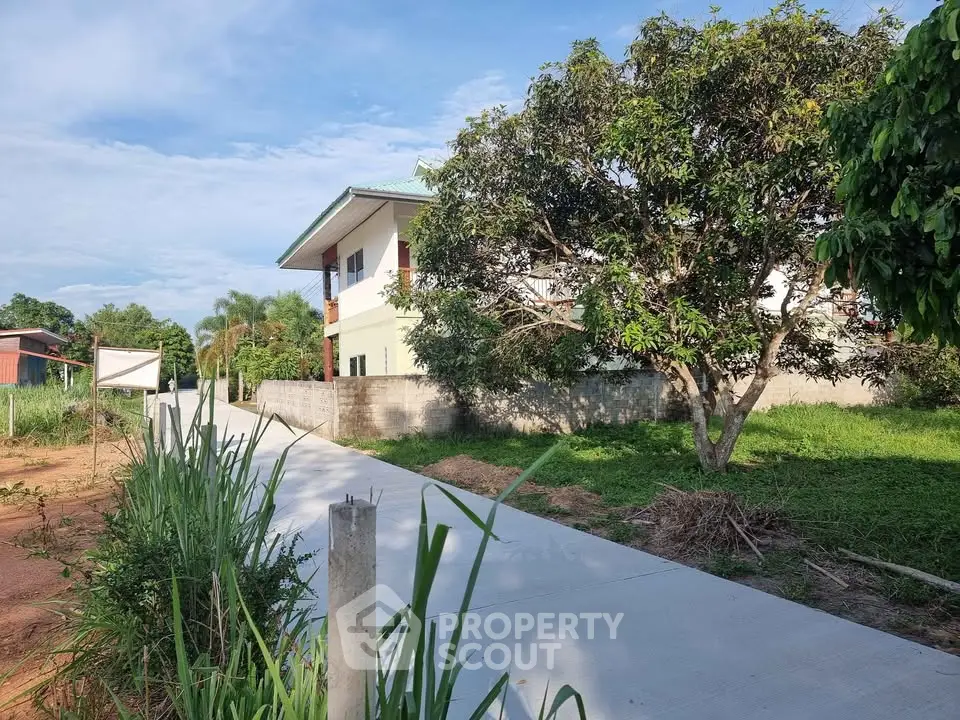 Charming suburban house with lush greenery and spacious driveway