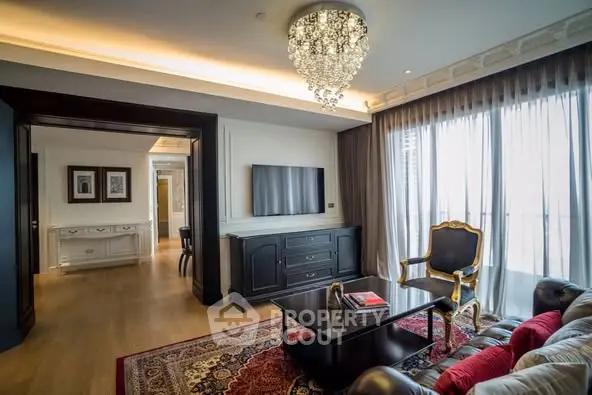 Luxurious living room with elegant chandelier and large windows