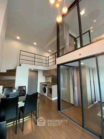 Modern loft apartment with open layout, stylish dining area, and mezzanine level.