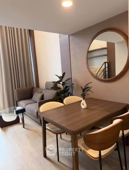 Modern living room with dining area, stylish furniture, and elegant decor
