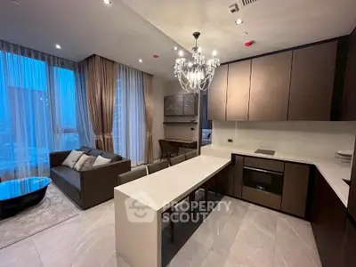 Luxurious modern living room with open kitchen and elegant chandelier