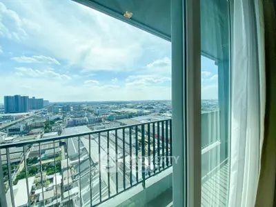 Stunning high-rise balcony view with expansive cityscape and clear blue sky.