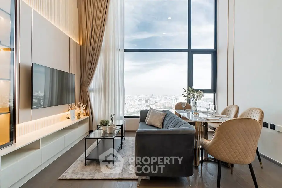 Luxurious high-rise living room with panoramic city views and elegant decor.