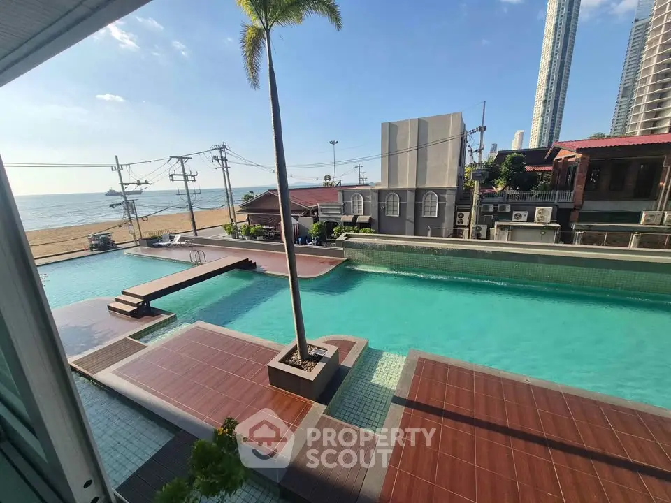 Stunning beachfront pool with ocean view in luxury real estate setting.