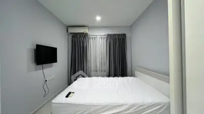 Modern bedroom with minimalist design, featuring a wall-mounted TV and air conditioning for comfort.