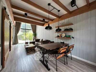 Stylish living room with wooden beams and modern furniture, perfect for cozy gatherings.