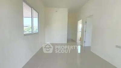 Spacious empty room with large window and glossy tiled floor