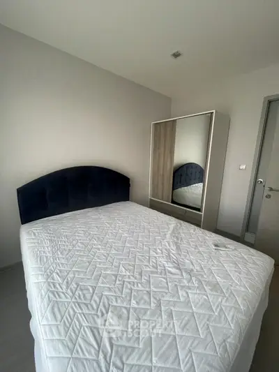 Modern bedroom with sleek design and comfortable bed in a stylish apartment.