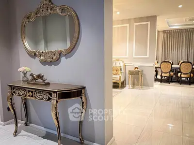 Luxurious living room with elegant decor and ornate furniture, featuring a stylish console table and mirror.