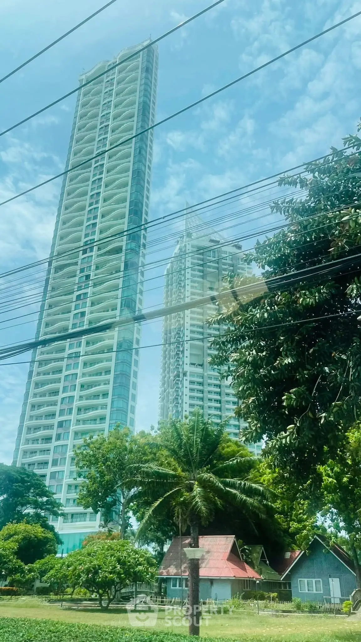 Stunning high-rise buildings with lush greenery and clear blue sky view
