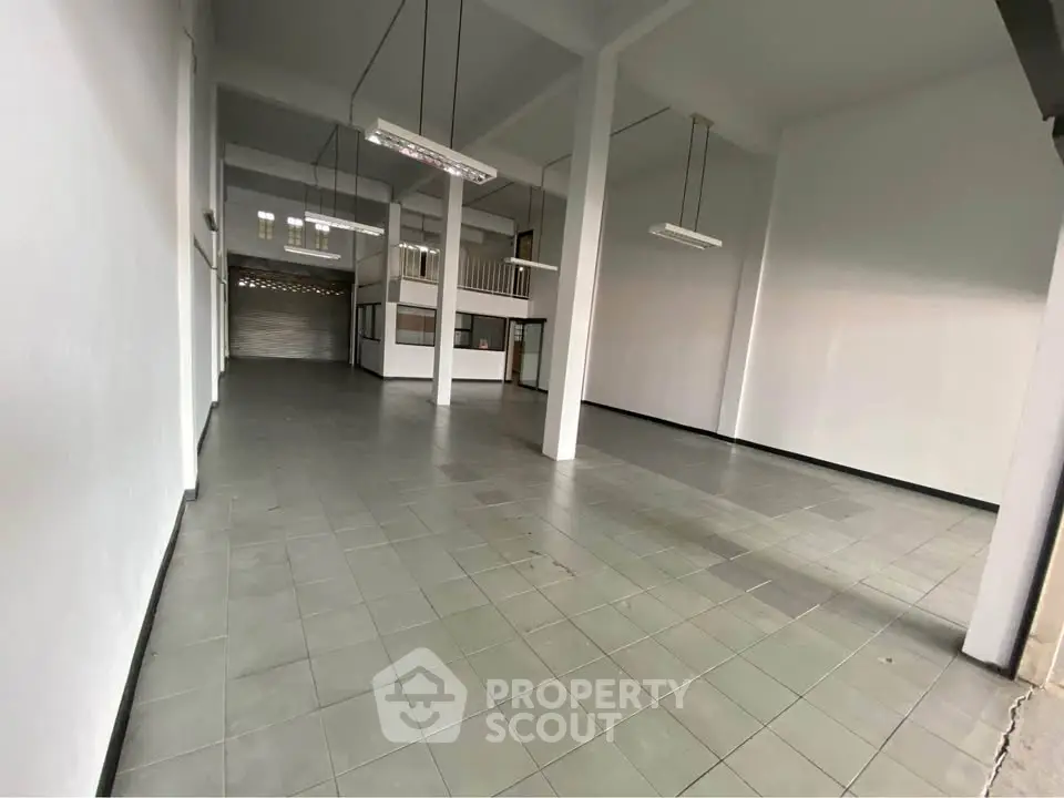 Spacious commercial property with high ceilings and ample natural light, ideal for business or storage use.